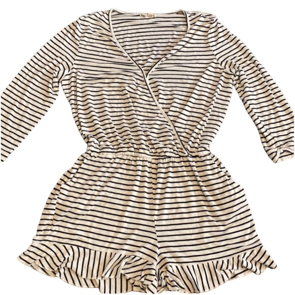 About a Girl romper. Size L. Black and white stripe. 1 closure at chest.